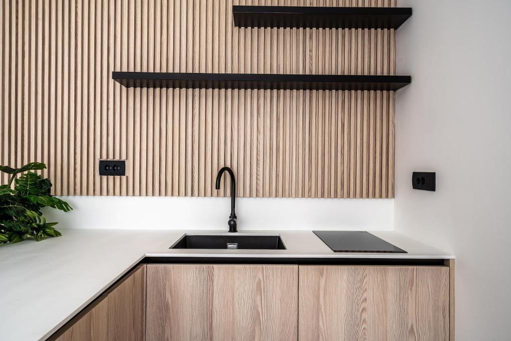 a kitchen with a sink and a counter top at Blanche Cliff Apartments in Sveti Stefan