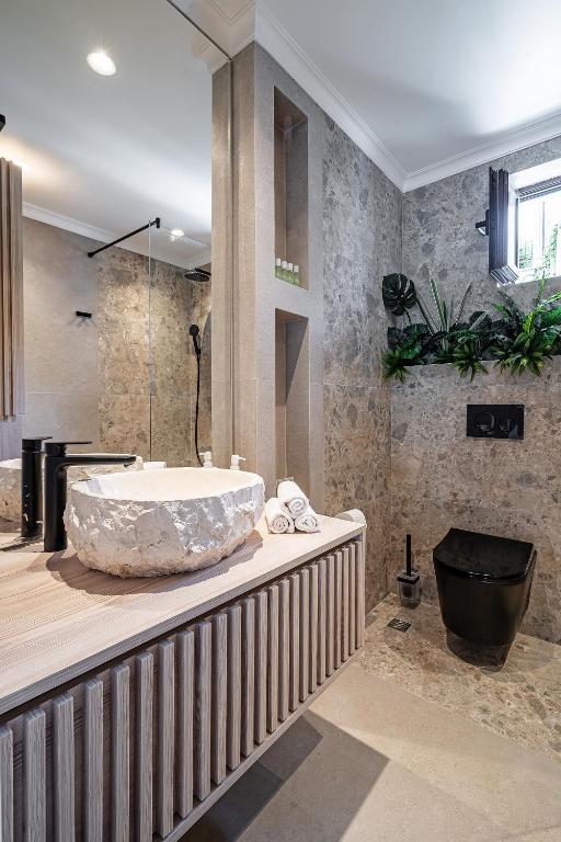 a bathroom with a large tub on a counter at Blanche Cliff Apartments in Sveti Stefan