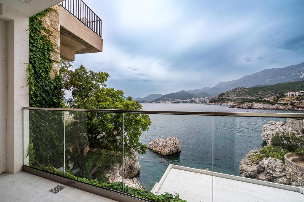 a balcony with a view of the water at Blanche Cliff Apartments in Sveti Stefan