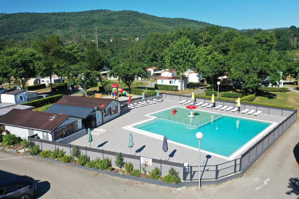 an overhead view of a swimming pool in a residential neighborhood at Camping du Lac in Foix