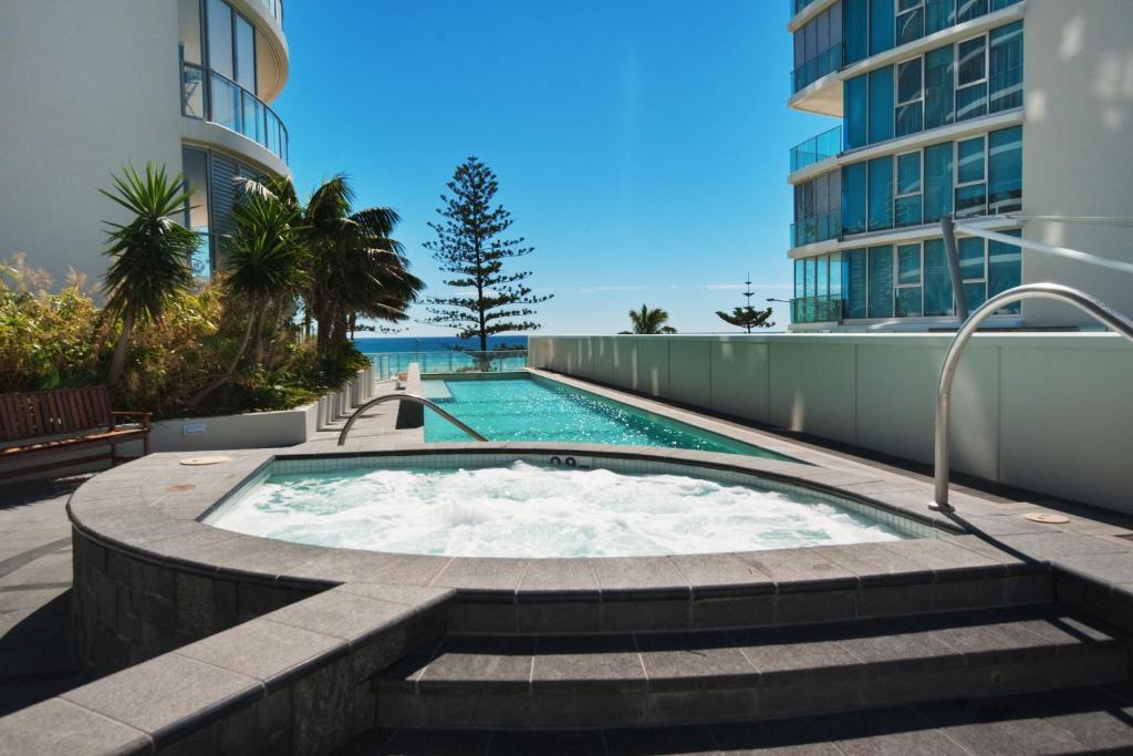 a pool with a pool table and a pool tub at Reflection Tower Two in Gold Coast