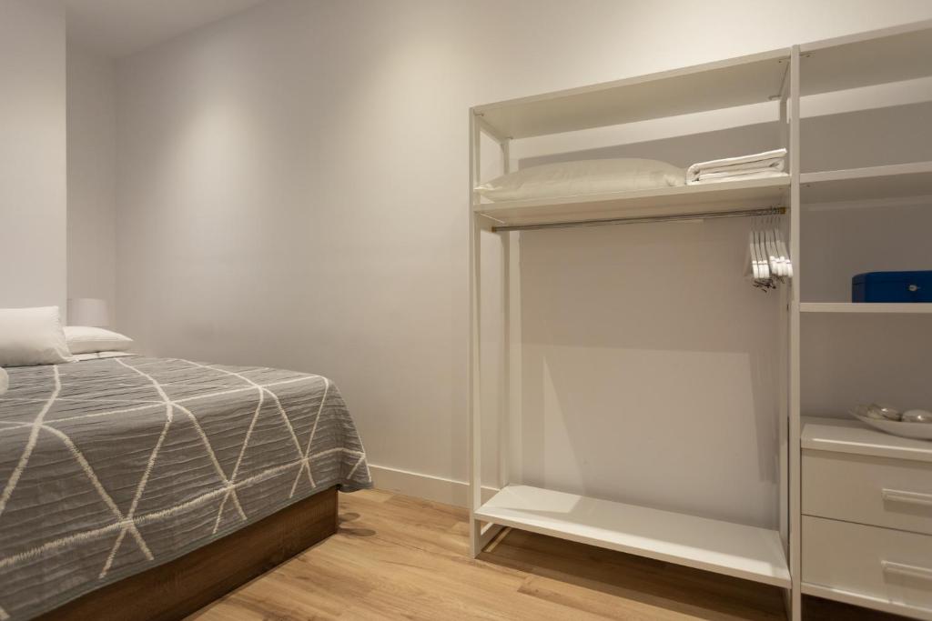 A bed or beds in a room at APARTAMENTOS ARRIET