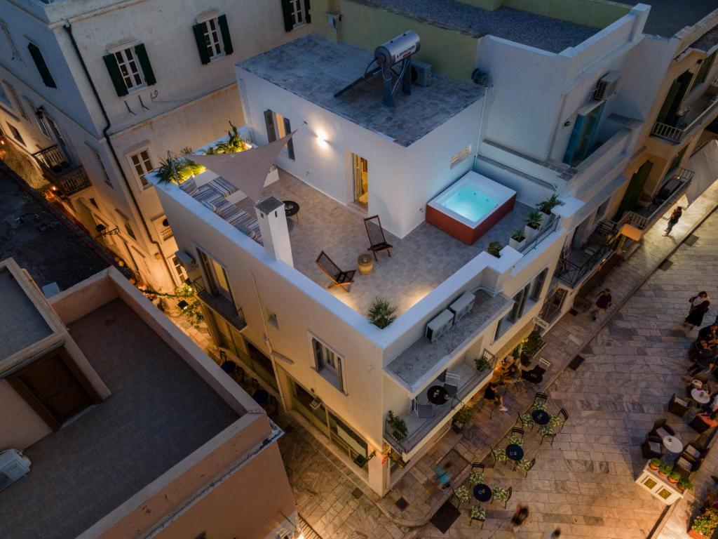 an overhead view of a house with a pool at Nomadic Cozy Rooms in Ermoupoli
