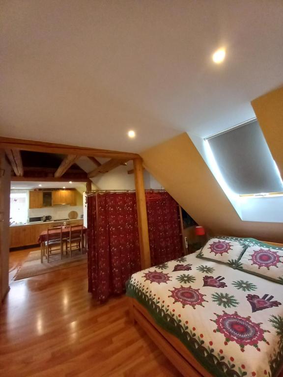 a bedroom with a bed and a dining room at U WOJTUSIA in Czarny Dunajec