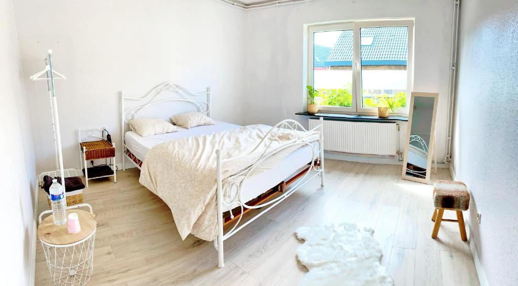 a bedroom with a white bed and a window at Residence Stay Eva Upstairs Brunch Café in Ghent