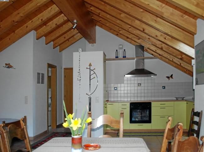 a kitchen with a table with yellow flowers on it at Appartamento N. 6 Casa Betulla in Sonogno