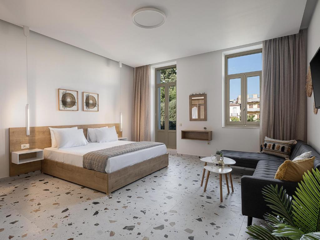 a hotel room with a bed and a couch at Cretan Berry Kondylaki in Chania