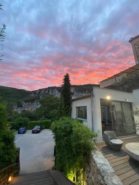 a view of a house with a sunset at Le Belvedere in Vallon-Pont-dʼArc