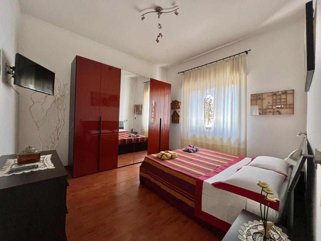 a bedroom with a large bed and a bathroom at villino Morena in Torre del Lago Puccini