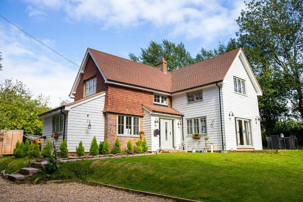 a white house with a brown roof at Inviting 5-Bed House in 1066 County - Battle in Battle