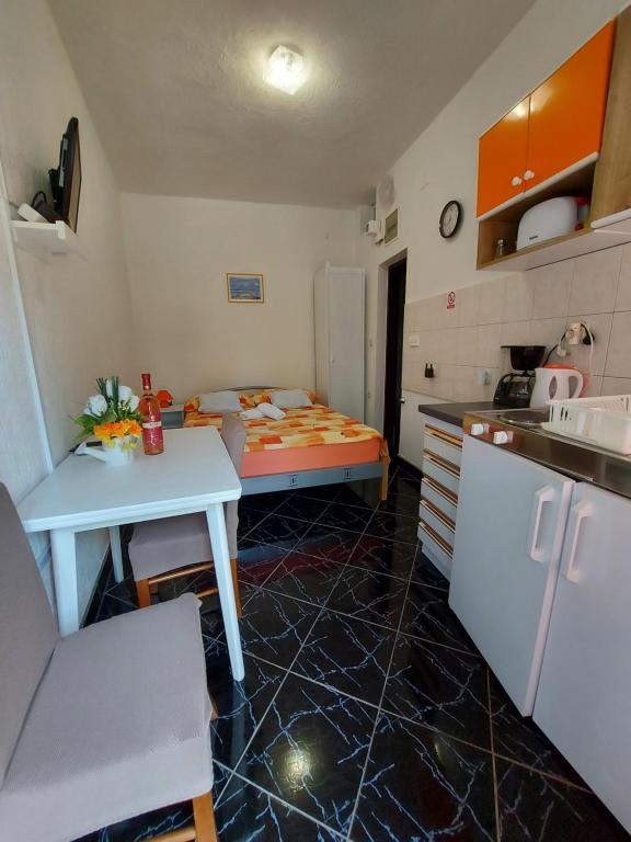 a kitchen with a table and a bed in a room at Dalibor in Senj