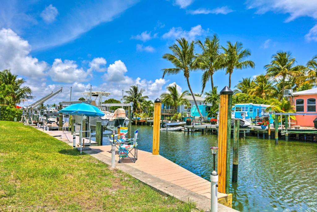 a marina at a resort with palm trees at Jensen Beach Home with Private Dock and Ocean Access! in Jensen Beach