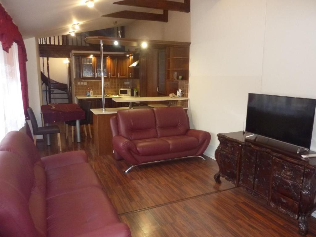 a living room with a couch and a flat screen tv at Alžbetina- Luxury Large Apartment 21 in Košice