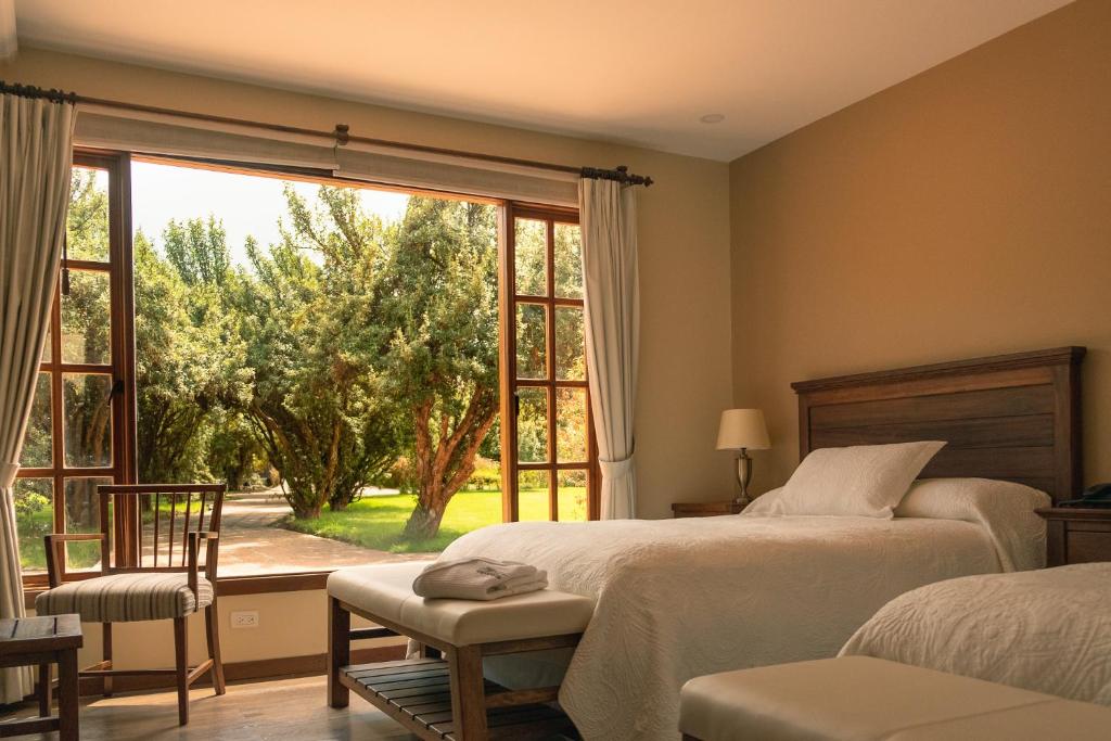 Postel nebo postele na pokoji v ubytování Hotel Hacienda Abraspungo