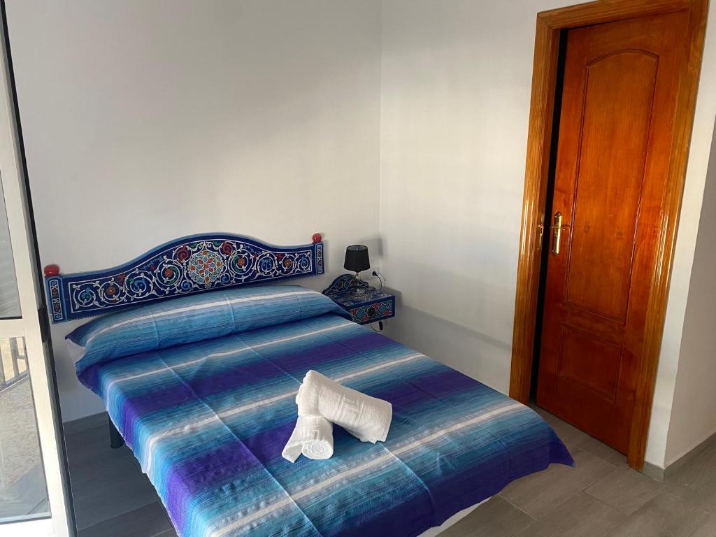 a bed with a pair of shoes sitting on it at Casa Salma in Seville