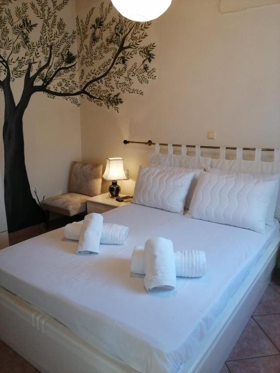 a large white bed with two pillows on it at Olive Tree House II in Dhermatiánika