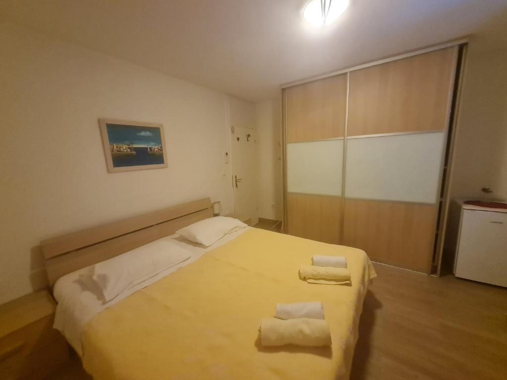 a bedroom with a bed with two towels on it at Rooms Anđelka in Bol
