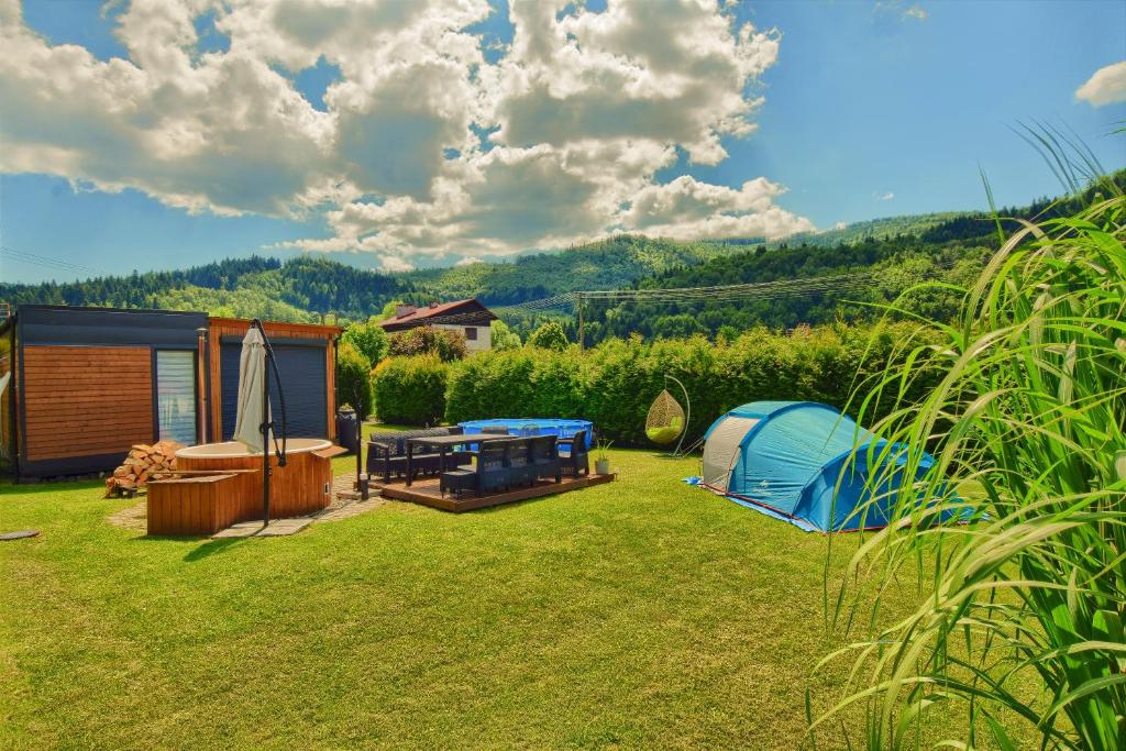 a backyard with a tent and a fire pit at Osada Kotarz in Brenna