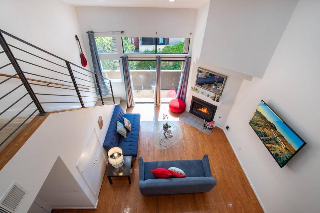 an overhead view of a living room with a blue couch at Franklin Hollywood Bowl Loft in Los Angeles