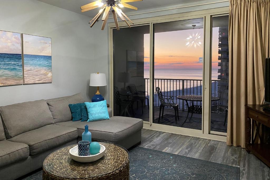 a living room with a couch and a view of the ocean at Shores of Panama III in Panama City Beach