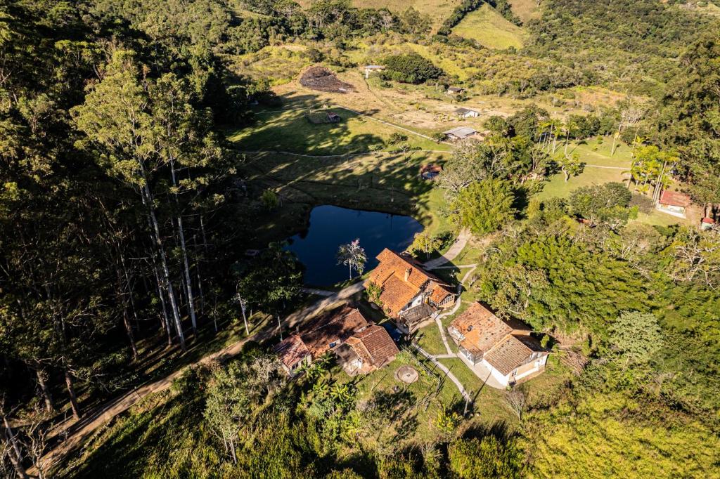 an aerial view of a house and a lake at Vila Cosmica in Lagoinha