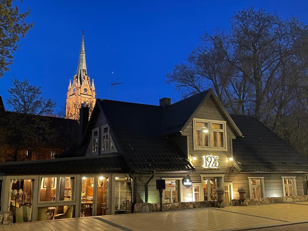 a building with a clock tower in the background at Apartment 1925 in Palanga