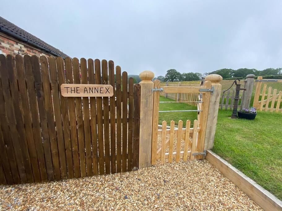 a wooden fence with a gate with a sign on it at Beautiful Rural Self Contained Farm Annex in Hordle