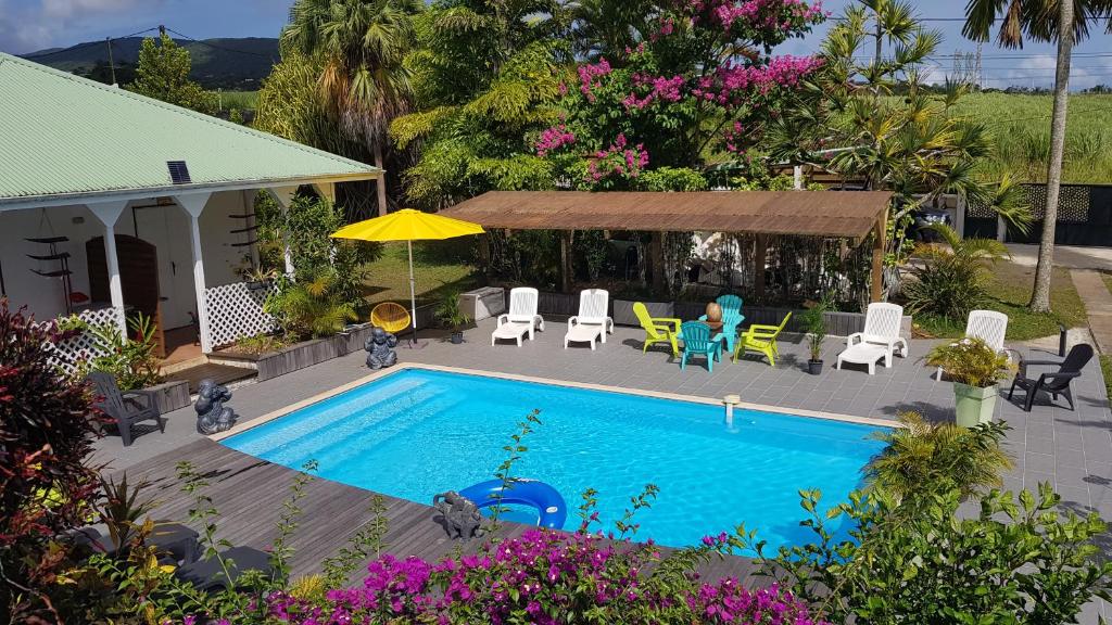 an overhead view of a swimming pool with chairs and tables at La Creolina in Sainte-Rose