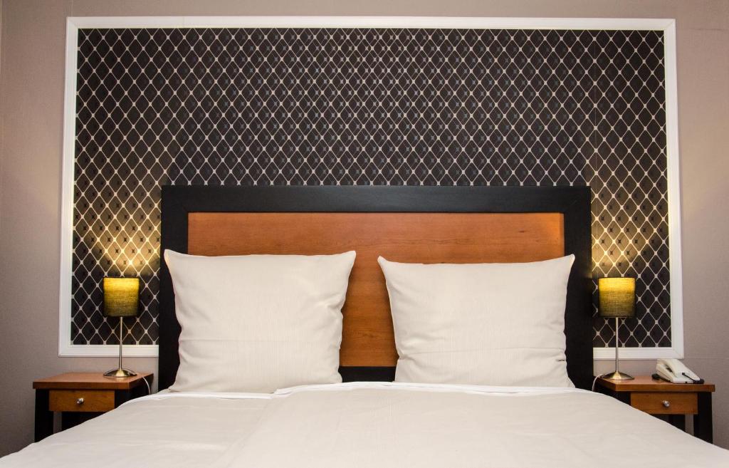 Postel nebo postele na pokoji v ubytování Hotel Borchers