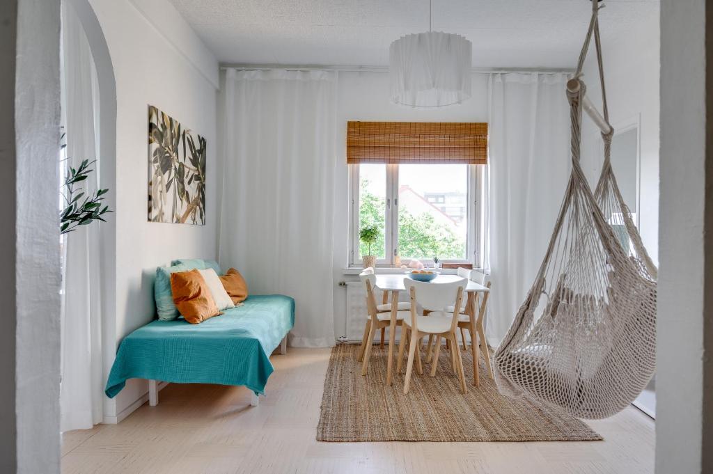a living room with a hammock in a room at Downtown apartment with views over city rooftops in Turku