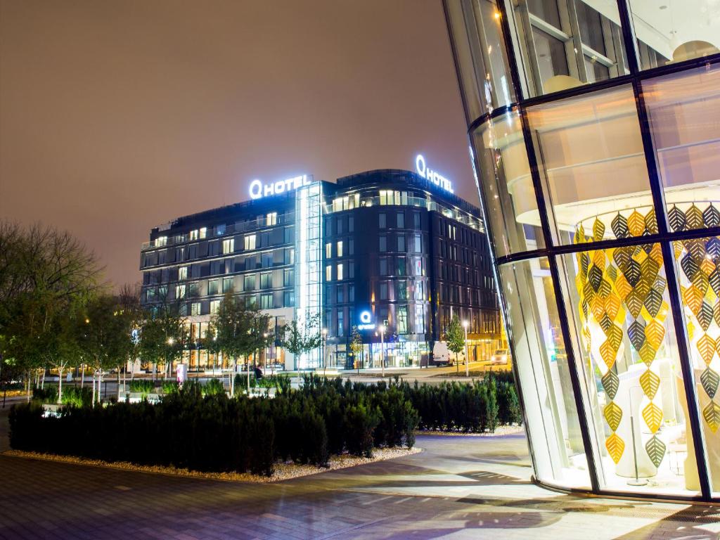 a building with a sign on it at night at Q Hotel Plus Kraków in Kraków