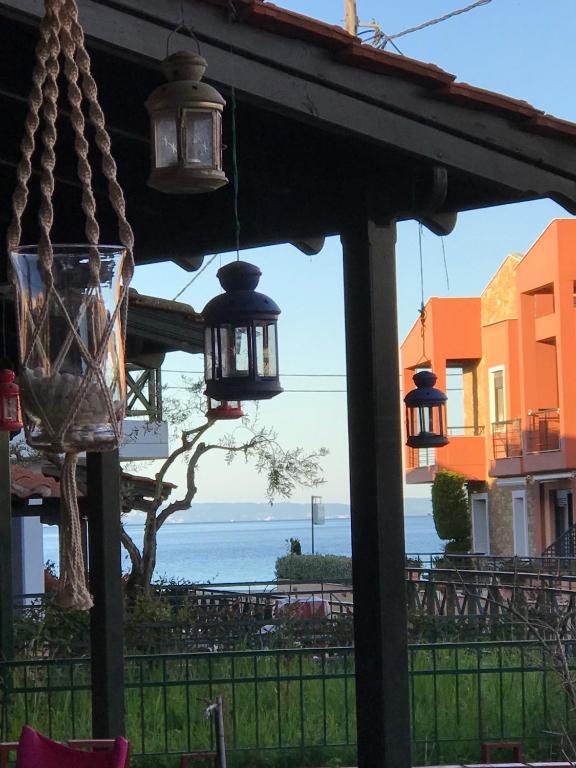 a view of the ocean from a porch with lights at Nikiti, four seasons house in Nikiti