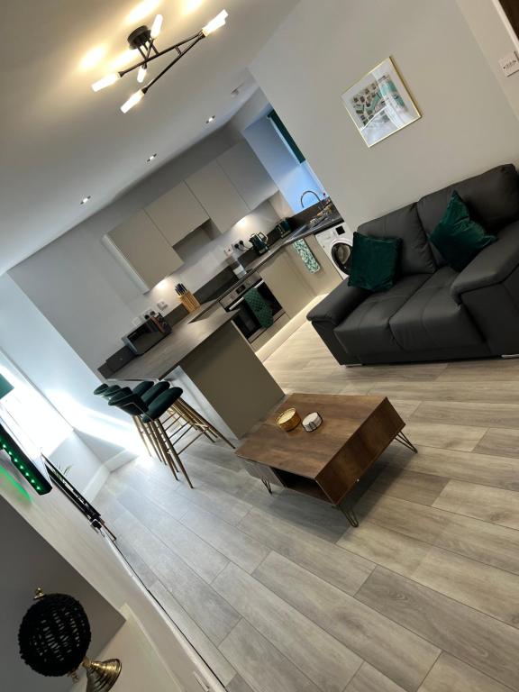a living room with a couch and a coffee table at Town centre 2 bed luxury apartment in Wick