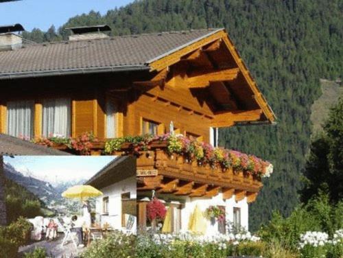 a building with a balcony with flowers on it at Ferienwohnungen Pötscher Maria in Matrei in Osttirol