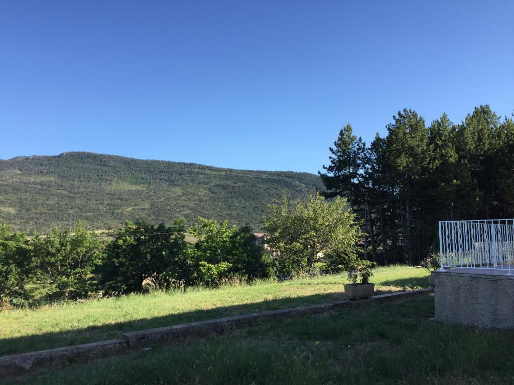 a view of a field with a mountain in the background at La belle étoile in La Palud sur Verdon