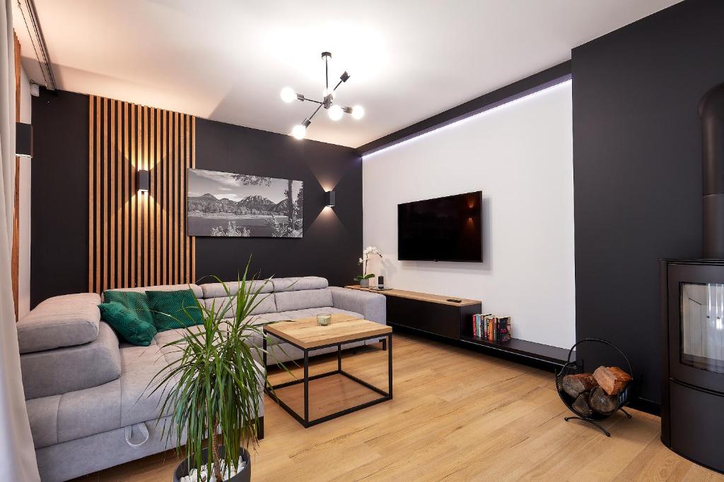 a living room with a couch and a table at Apartament Pieniny in Jaworki