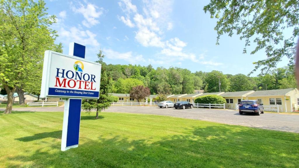 a sign for a home motel in front of a parking lot at Honor Motel in Honor