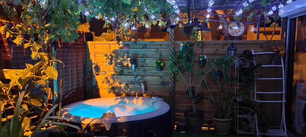 a hot tub in a room with plants and lights at Dépendance de 30m² dans maison avec entrée privée in Six-Fours-les-Plages