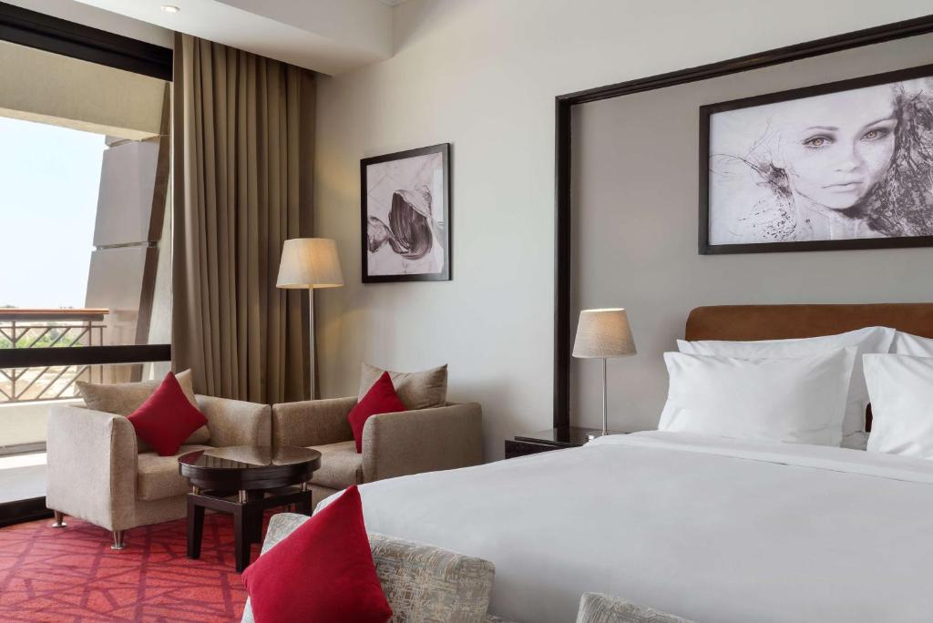 A bed or beds in a room at Radisson Blu Hotel & Convention Center, Alexandria