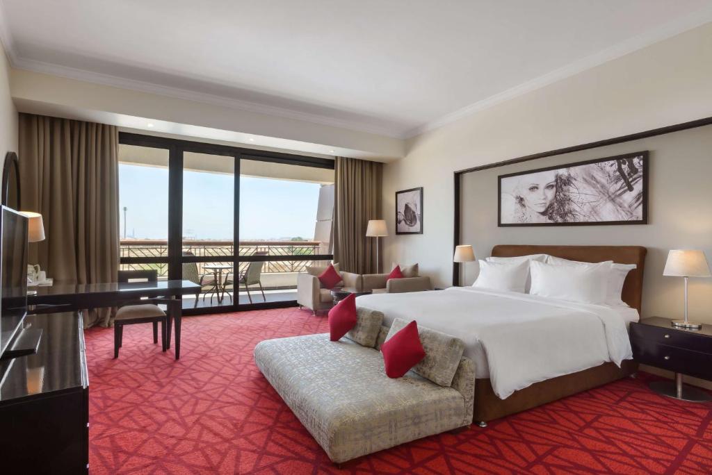 A bed or beds in a room at Radisson Blu Hotel & Convention Center, Alexandria