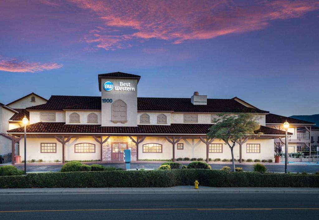 a building with a sign on the side of it at Best Western Corona Hotel & Suites in Corona