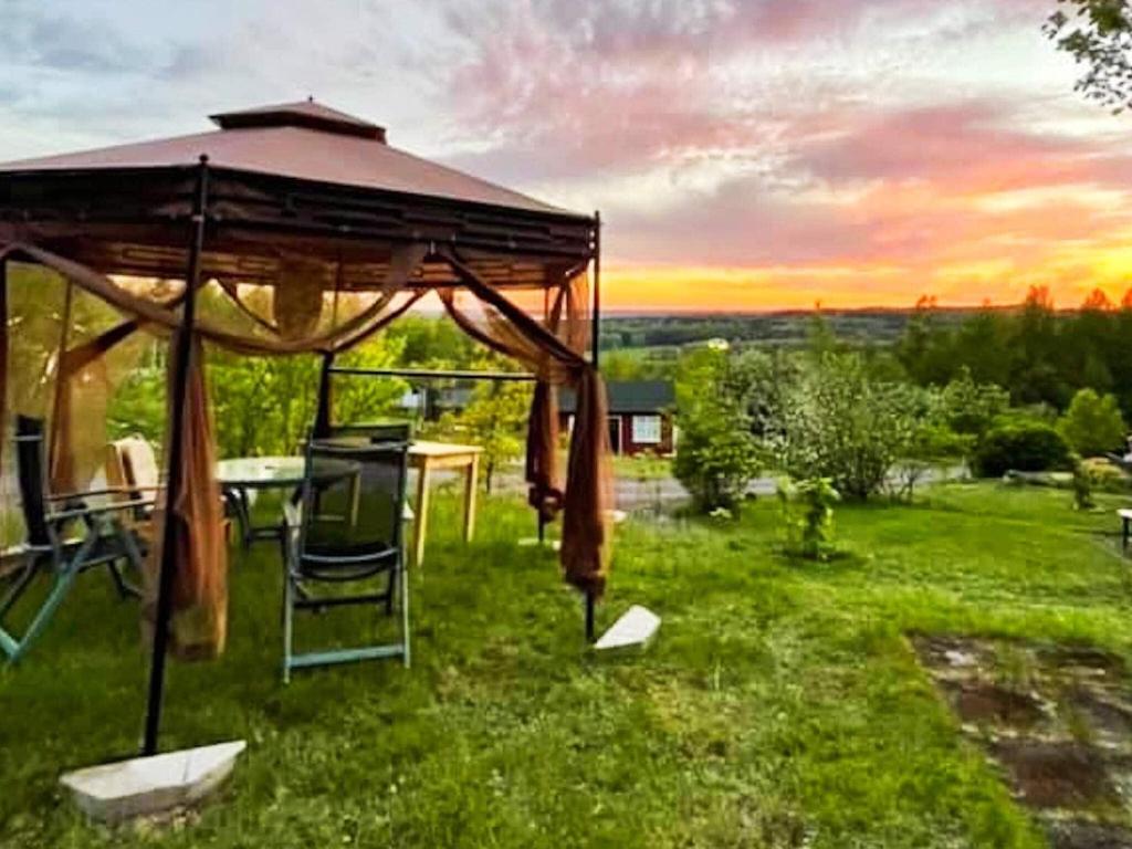 a gazebo with a table and chairs in the grass at 4 person holiday home in UNDEN S in Undenäs