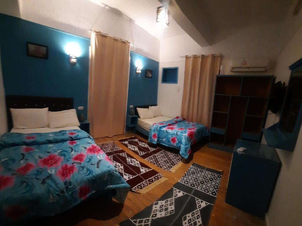 a small bedroom with a bed and a table at happy life hostel in Cairo