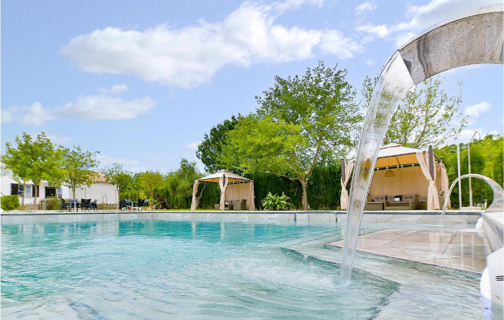 a swimming pool with a fountain in the middle at Awesome Home In El Coronil With Wifi in El Coronil