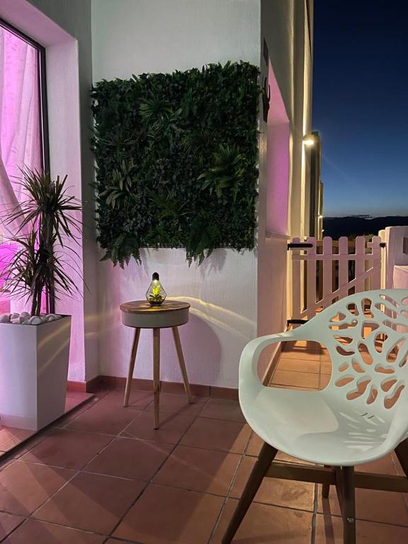 a table and a chair in a room with a plant at Casa Beau Murcia, Condado de Alhama in El Romero