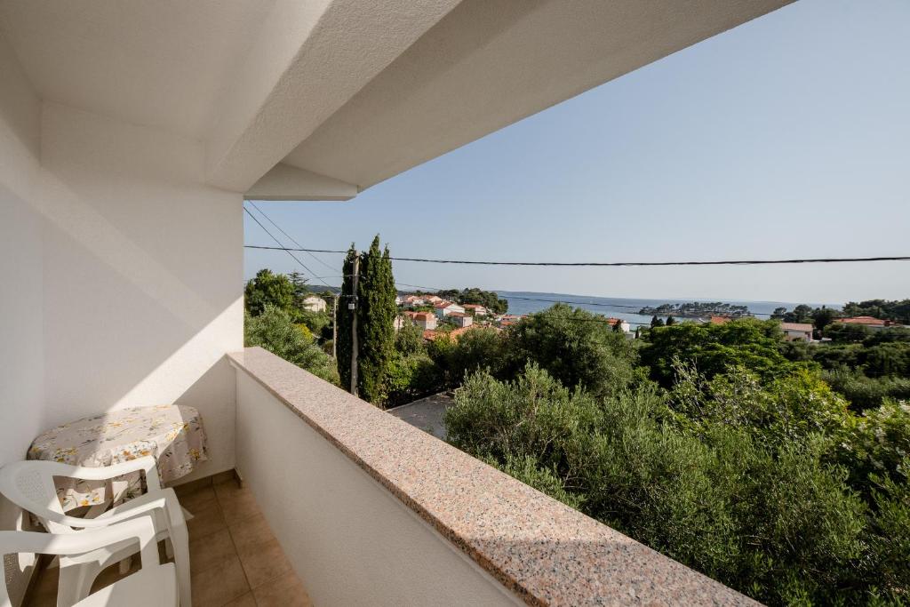 a balcony with a view of the ocean at Apartments Mladenka in Banjol in Banjol