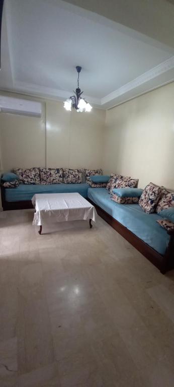 a room with two beds and a table in it at apartment 2 bedrooms in agdal in Rabat