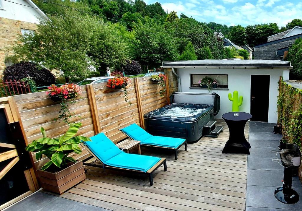 eine Terrasse mit 2 Stühlen und einem Whirlpool in der Unterkunft Ol folle spa in Malmedy