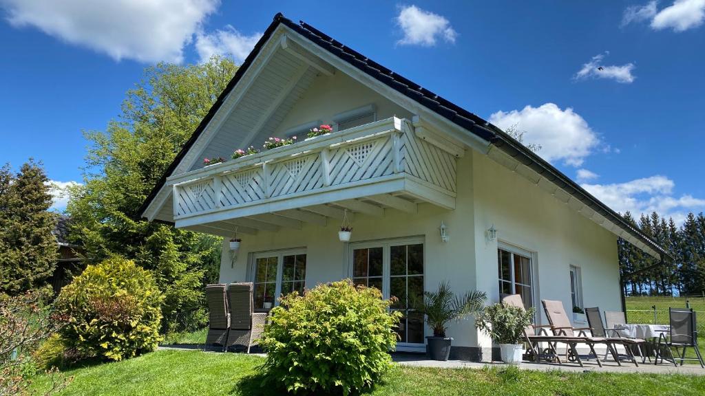 a white house with a balcony on top of it at Ferienhaus Vogtlandresidenz in Auerbach