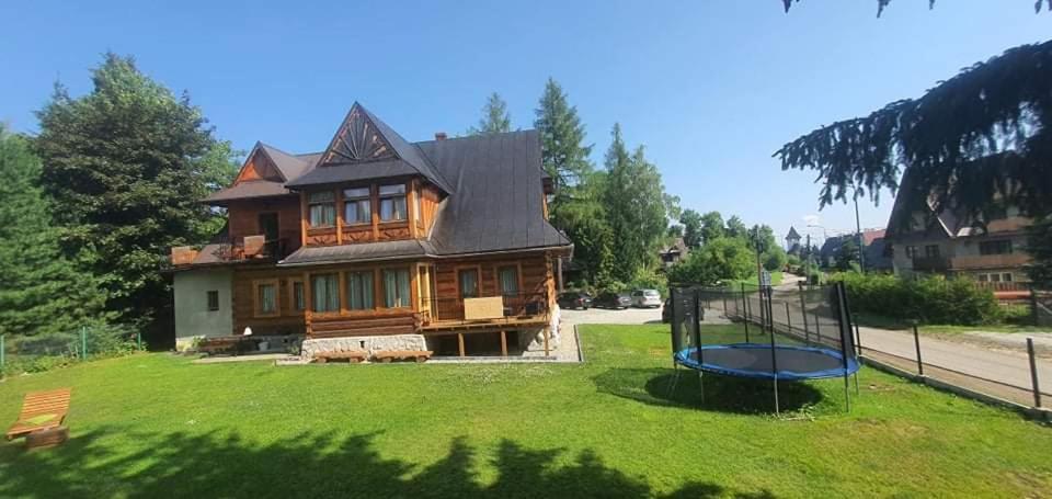 a large house with a playground in front of it at Pokoje regionalne u Ani in Zakopane